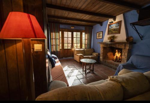 a living room with a couch and a fireplace at Cabañas Jimera de Líbar in Jimera de Líbar