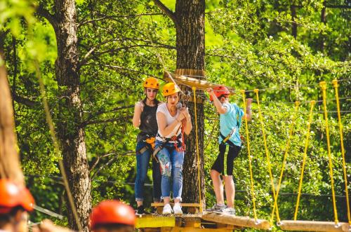 a group of people wearing hard hats on a zip line at Pensiunea Agroturistica Cerna, Vaideeni - Polovragi in Vaideeni
