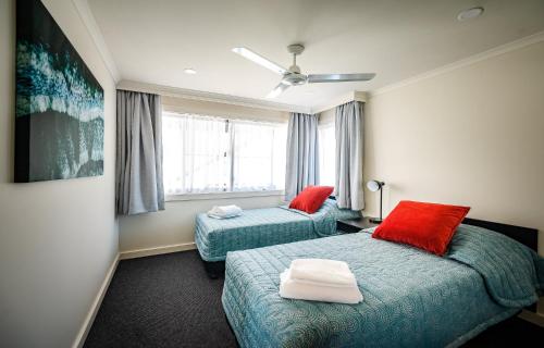 A bed or beds in a room at Riverside Holiday Resort Urunga