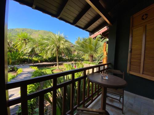 a balcony with a table and a view of a garden at Villa Bebek Hotel in Camburi