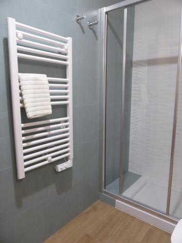 a towel rack in a bathroom with a shower at Bento Boutique Apartment - IBG HOME in Lisbon