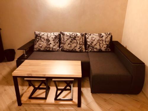 a living room with a couch and a table at Gostynna sadyba Kit Bayun in Teterivka