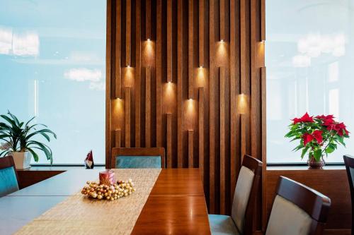 a dining room with a table with chairs and lights at Hotel Buchenland in Gura Humorului
