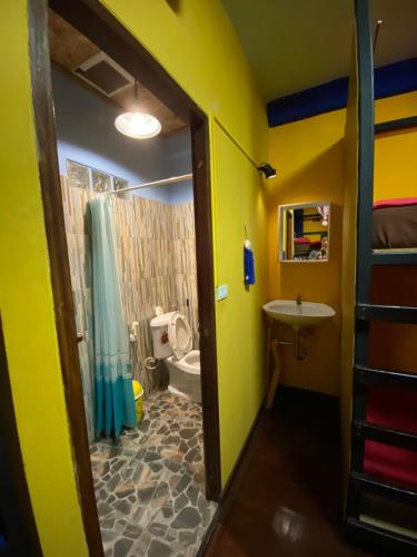 a bathroom with a shower and a toilet and a sink at At Home Hostel, Pak Chong in Pak Chong