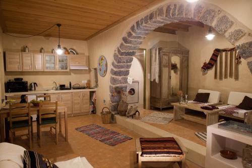 a kitchen and living room with a stone archway at Sitanos Athena House in Sítanos