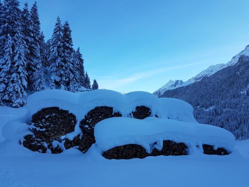 a pile of snow on a rock in the snow at Bäckerei Schranz in Sankt Leonhard im Pitztal