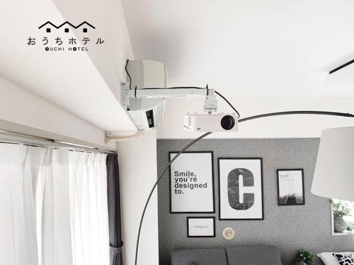 a room with a light on the wall at OUCHI HOTEL Takaramachi in Hiroshima