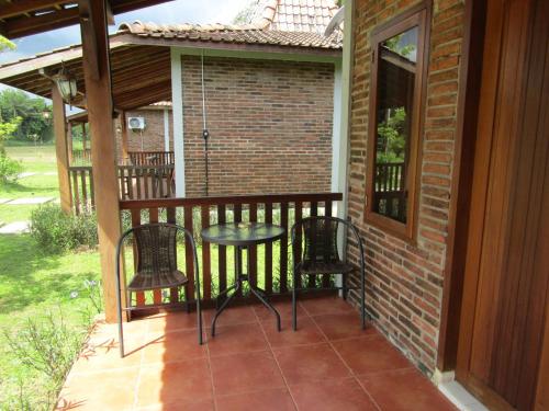 a patio with chairs and a table on a balcony at Balkondes Bumiharjo (Kampung Dolanan) in Magelang