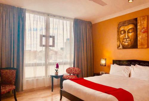 a hotel room with a bed and a large window at CBD Hotel in Dar es Salaam