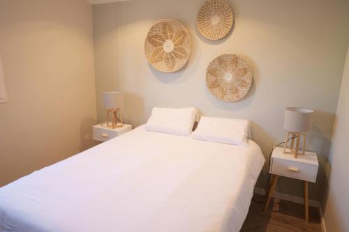 a bedroom with a large white bed with two night stands at Appart T2 avec terrasse, parking et wifi in Angoulême