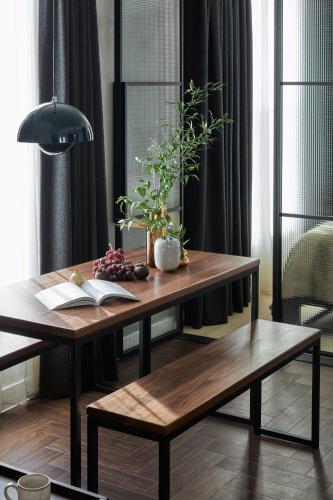 a table and bench with a book and plants on it at Staycity Aparthotels London Dalston in London