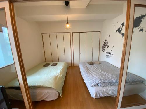 Postel nebo postele na pokoji v ubytování ETERNITY Tamatsukuri 401