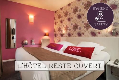 a hotel reserve outpost room with a bed with red and white pillows at Hôtel Soft in Paris