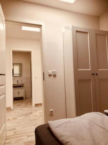 a bedroom with a door leading to a bathroom at Ferienwohnungen Mey Haus zum Rosenstock in Erfurt