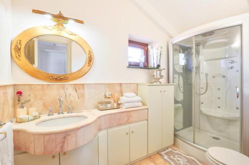 a bathroom with a sink and a shower and a mirror at Casa Spartano in Sorrento