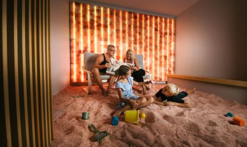 a group of people sitting in a room with sand at Hotel Thermana Park Laško**** Superior in Laško