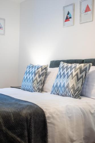 a bed with two pillows on top of it at No11 Nursery Covent in Mansfield