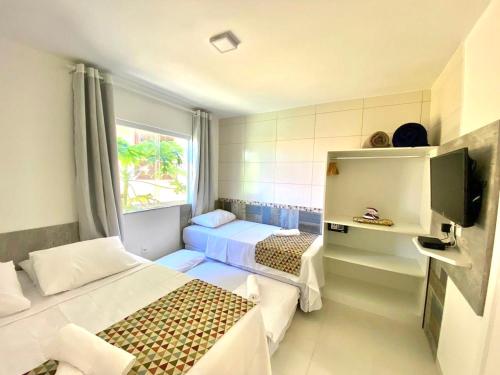 Ένα ή περισσότερα κρεβάτια σε δωμάτιο στο Flats Morro de São Paulo
