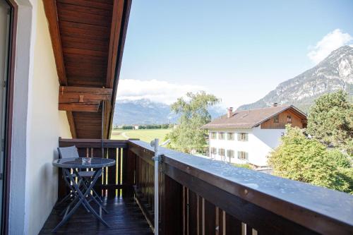 a balcony with a table and a view of mountains at Lichtblick in Farchant