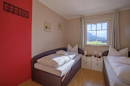 a bedroom with two beds and a window at Lebensfreude in Farchant