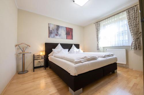 a bedroom with a large bed and a window at Alpensonne in Garmisch-Partenkirchen