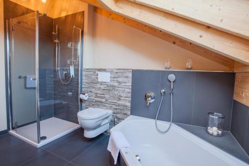 a bathroom with a toilet and a glass shower at Rundblick in Farchant