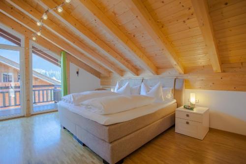 a bedroom with a large bed and a large window at Rundblick in Farchant