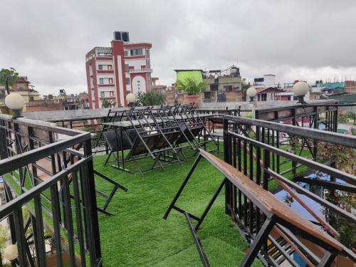 a group of chairs sitting on top of a balcony at Yog Hostel- Rooftop Yoga & Backpacker Social Stay in Thamel, Kathamndu in Kathmandu
