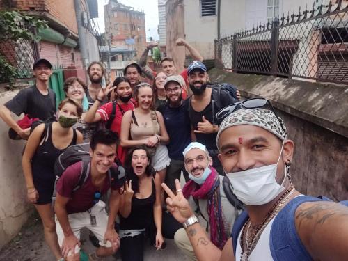 a group of people posing for a picture in a street at Yog Hostel- Rooftop Yoga & Backpacker Social Stay in Thamel, Kathamndu in Kathmandu
