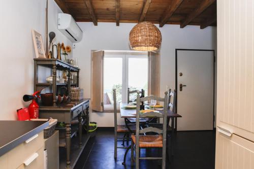 a kitchen with a table and a dining room at FLH Mira Guincho House with Sea View and Garden in Alcabideche