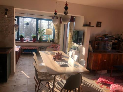 a dining table and chairs in a living room at Apartamenty Lavender Hill in Wisła