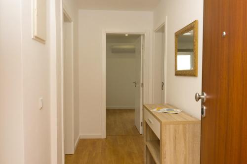 a bathroom with a wooden counter and a mirror at Love apartment Beco Torto, Cascais in Cascais