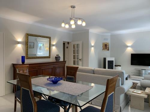 a living room with a table and a couch at FLH Cascais Posh Apartment in Cascais