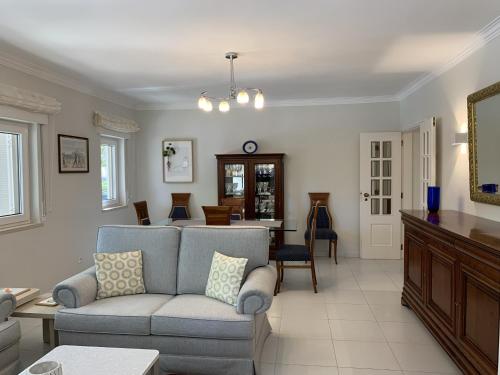 a living room with a couch and a table at FLH Cascais Posh Apartment in Cascais