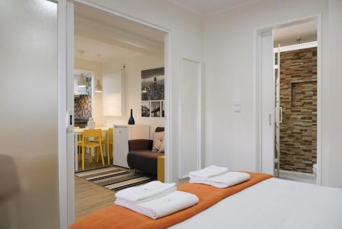 a bedroom with two beds and a living room at A piece of paradise in the heart of Cascais in Cascais