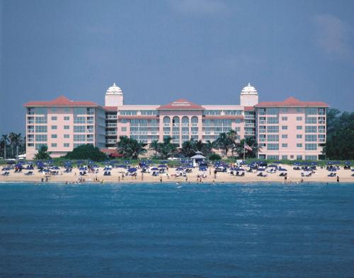 a large hotel on a beach with people on the beach at Palm Beach Shores Resort and Vacation Villas in Palm Beach Shores