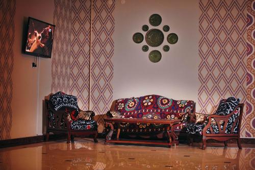 a living room with two chairs and a couch at Mixt Royal Palace in Samarkand