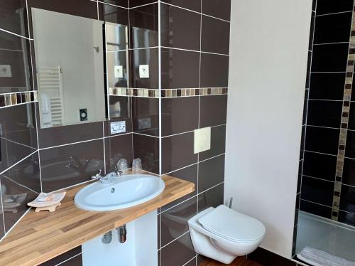 a bathroom with a sink and a toilet at Best Western Hôtel Des Voyageurs in Fougères