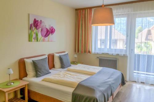 Ένα ή περισσότερα κρεβάτια σε δωμάτιο στο Gasthof-Pension Golob