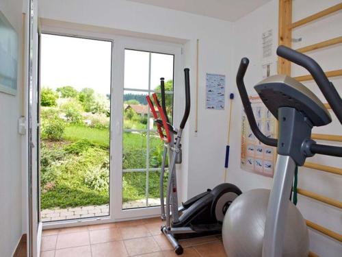 a room with a gym with a treadmill and a window at Ferienwohnung Linde in Bad Endorf