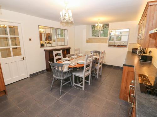 a kitchen and dining room with a table and chairs at Yr Hen Ysgol, The Old School in Porthmadog