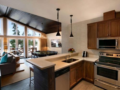 a kitchen with a stove top oven and a microwave at Fairmont Jasper Park Lodge in Jasper