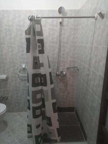 a shower with a black and white shower curtain in a bathroom at Ghazala Oasis Hotel in Dahab