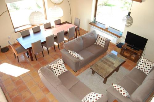 a living room with a couch and a table at Casa Rural El Entamáu in Argüero