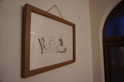a drawing of a couple sitting in a chair at Guesthouse Ten-roku - Female Only in Osaka