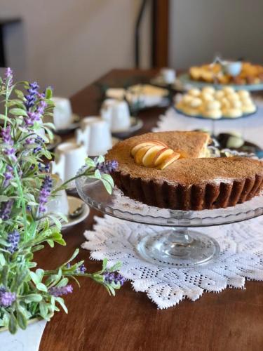 a table with a chocolate pie on a glass plate at Pousada das Lavandas in Campos do Jordão
