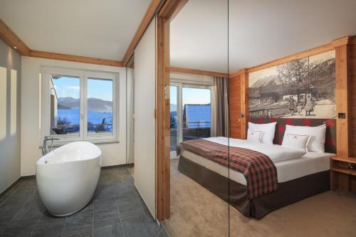 a bathroom with a bed and a bath tub and a bath tub at Dein Engel in Oberstaufen
