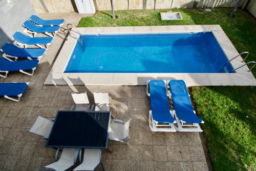 an overhead view of a swimming pool with lounge chairs and a table and a pool at Villa Lovisi in Maspalomas
