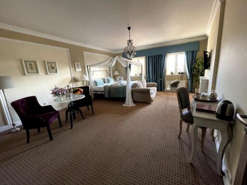 a hotel room with a bed and a table and chairs at Amálka u Řípu in Straškov