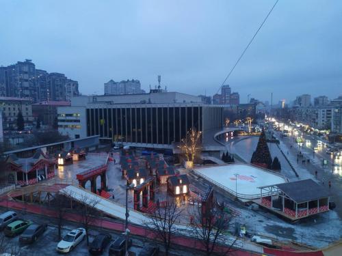 a view of a city at night with a rink at 7 Sky on Shchorsa Street in Kyiv